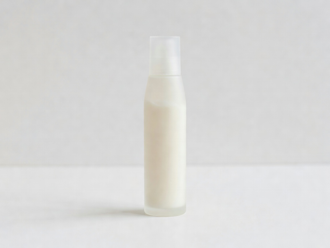 Slim fluid sunscreen bottle standing on a plain white surface