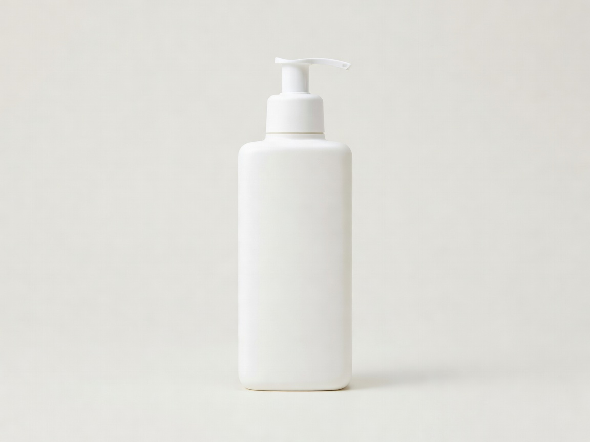 White pump bottle of hydrating cream cleanser on a plain light background
