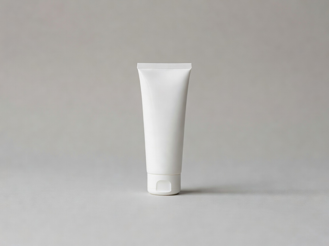 Tube of gentle facial cleanser on a soft grey backdrop